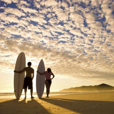 2 surfers on beach CA
